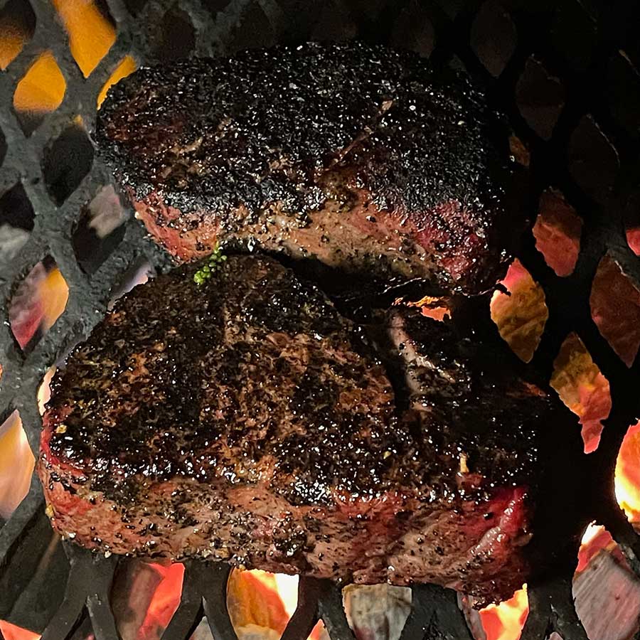 Two steaks on a grill